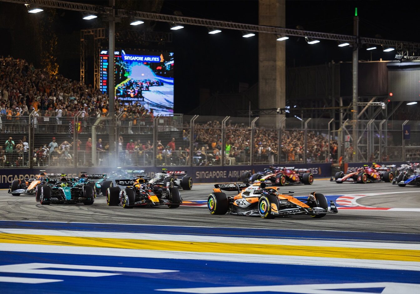 F1 cars racing through