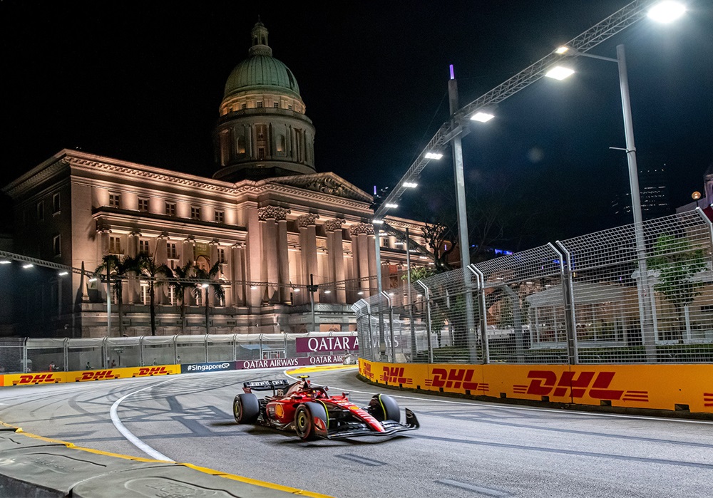 F1 car zooming past the building.